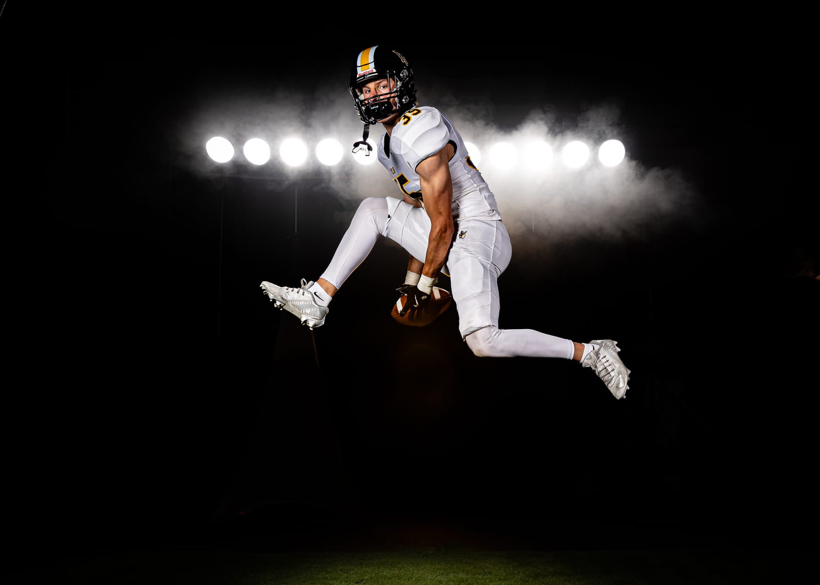 PLU football receiver leaping mid-air for the catch