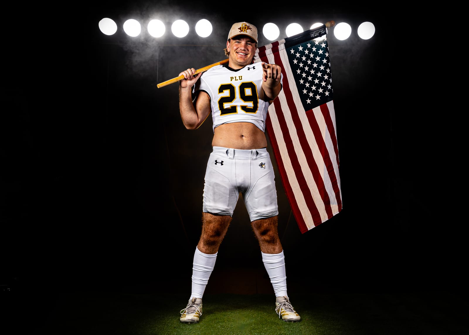 PLU football player with an American flag on media day