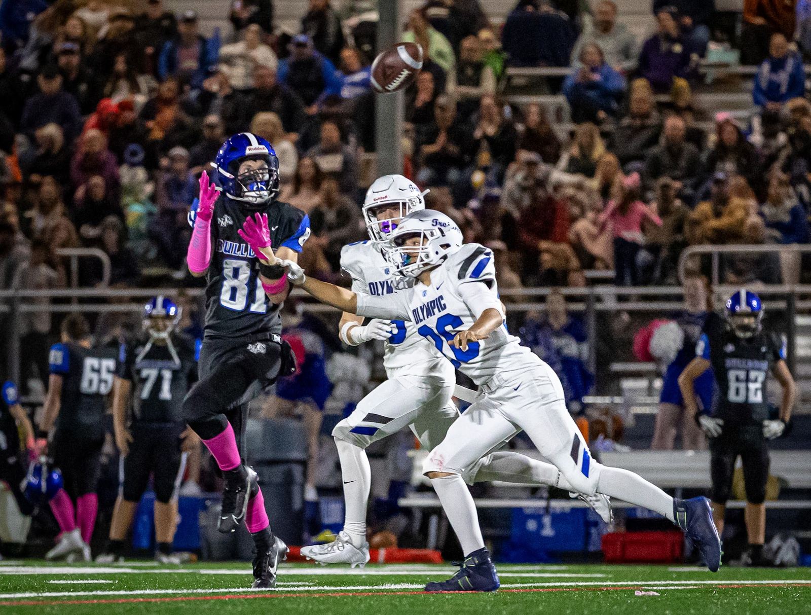 Friday night football action in front of a packed crowd
