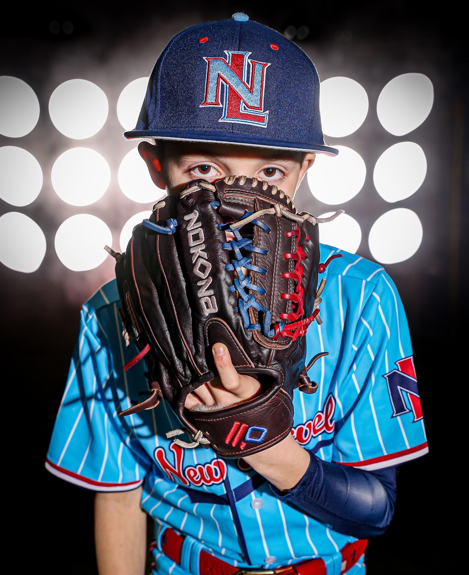 Young ballplayer holding his glove up to the camera