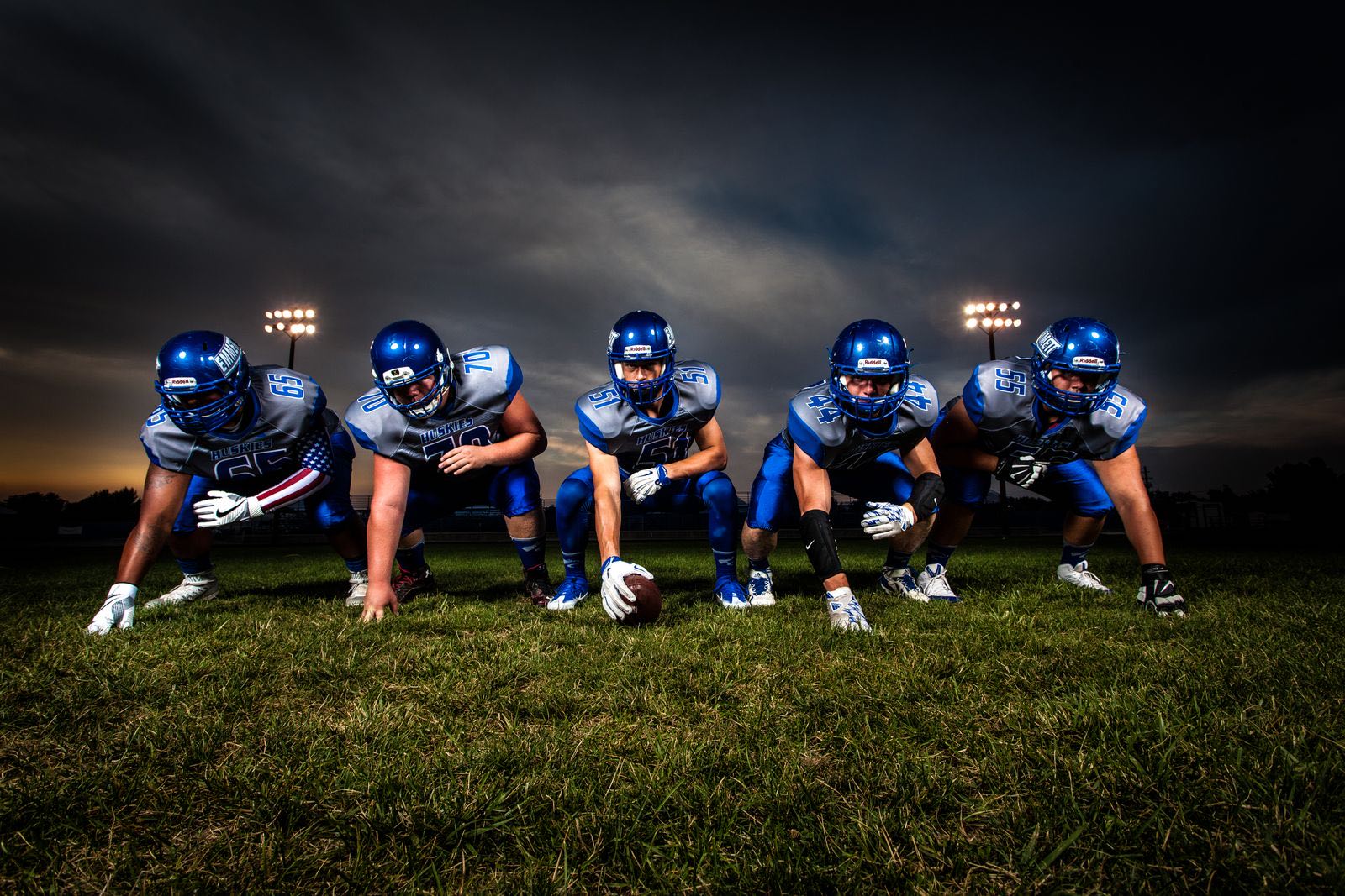 The line set under stadium lights, waiting on the snap