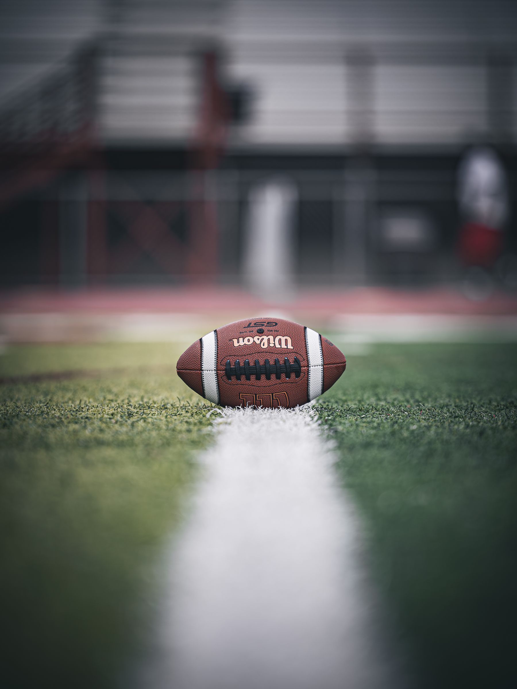 A football sitting on the fifty yard line