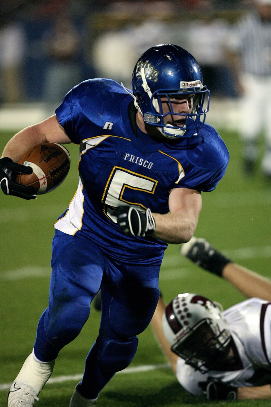 Running back breaking free during a night game